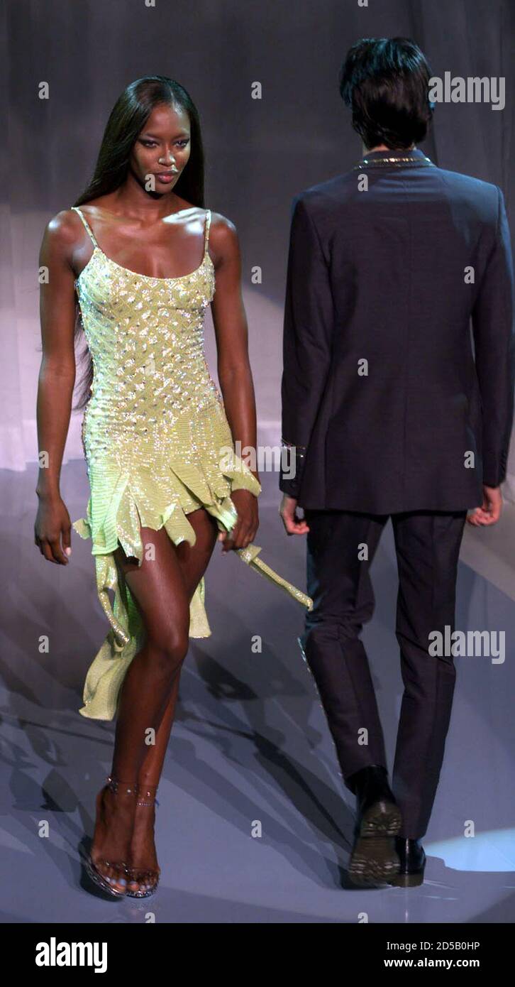 British top model Naomi Campbell (L) displays an evening dress during the Gianni  Versace fashion show, during the first day of the men's ready-to-wear  Spring/Summer 2000 collection in Milan June 27. The