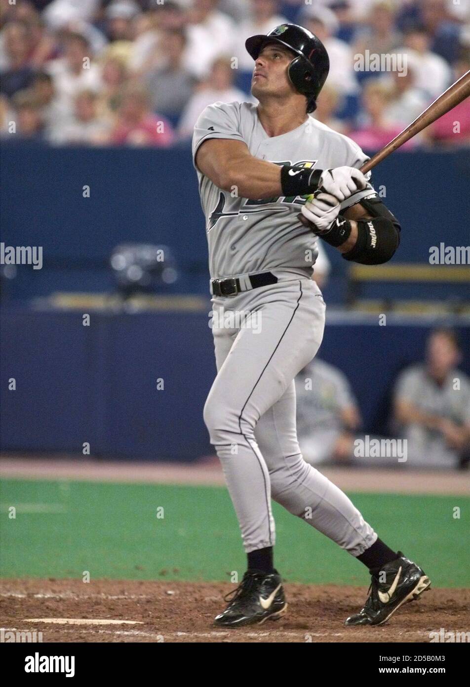 Tampa Bay Devil Rays' DH Jose Canseco watches his 30th home run, a  solo-shot to left field off Toronto Blue Jays' starting pitcher Pat  Hentgen, during the fourth inning at the SkyDome