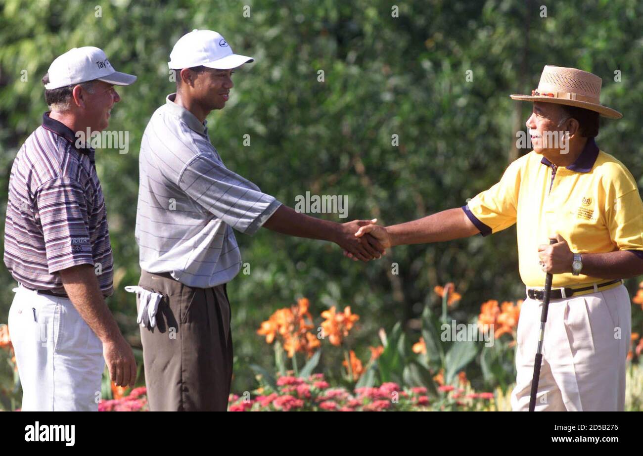 Tiger Woods (C) and Mark O'Meara of the United States greets former  Malaysia's King Tuanku Jaafar (R) during the Pro-Am of the World Cup Golf  tournament in Kuala Lumpur November 17. The