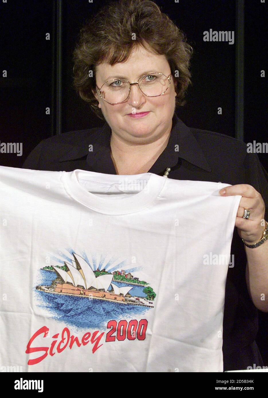 Amanda Vanstone, Australian Minister for Justice and Customs displays a  counterfeit t-shirt at a news conference February 24. With only months to  go before the Sydney 2000 Olympic Games, Australian customs is