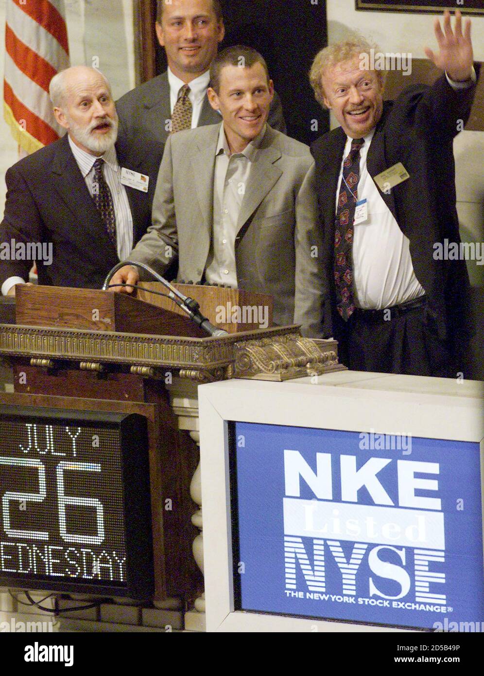 Year 2000 Tour de France champion Lance Armstrong (C) rings the closing  bell on the New York Stock Exchange as Nike Chairman and CEO Phil Knight  (R) waves to traders on the