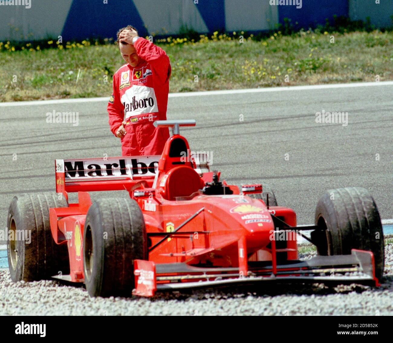 Germany's Formula One world champion driver Michael Schumacher with his  Ferrari car after spinning off during a training session at Montmelo race  track April 3. [Ferrari, Jordan and Williams team's are testing