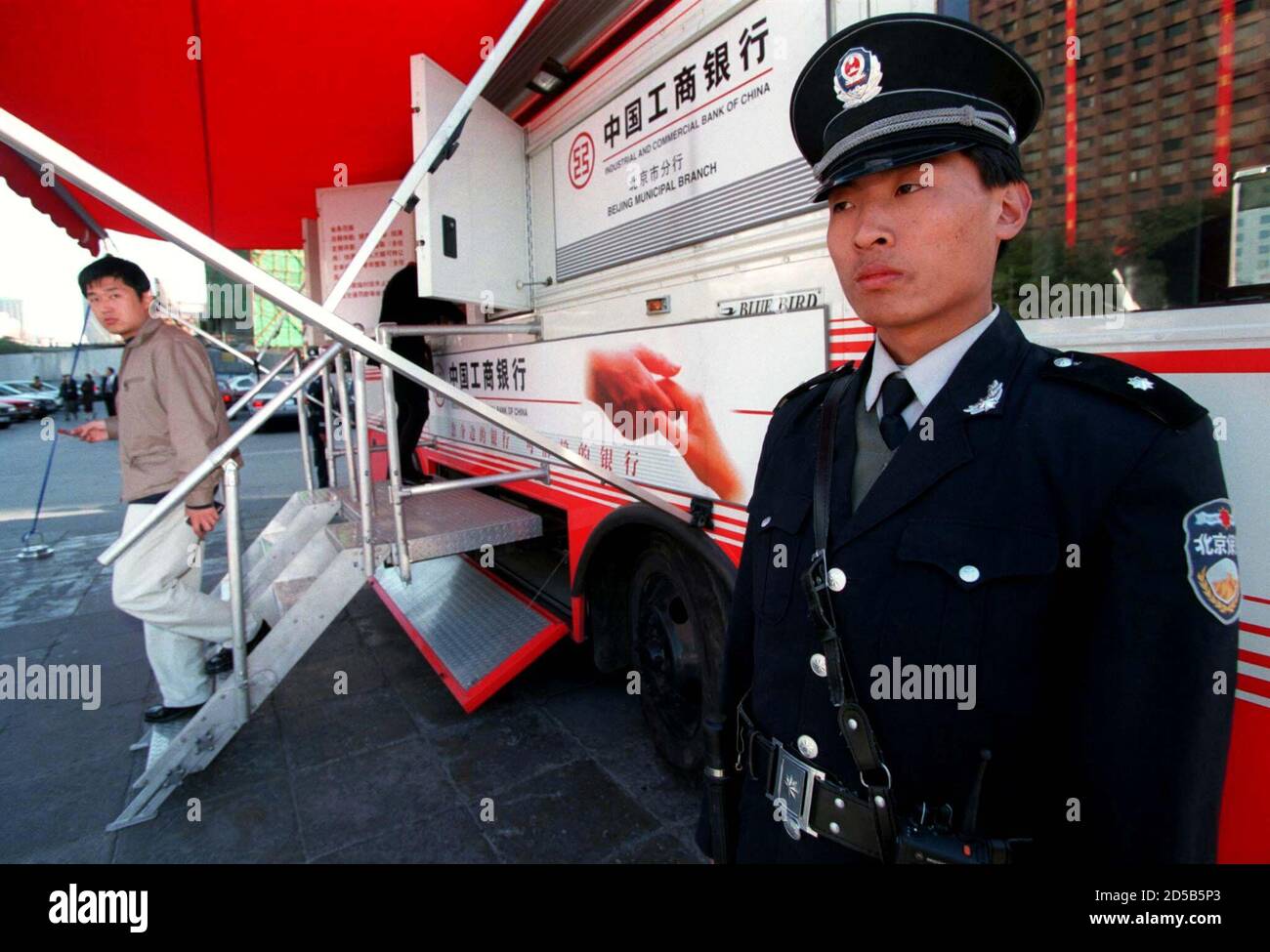 A Chinese security guard is posted in 