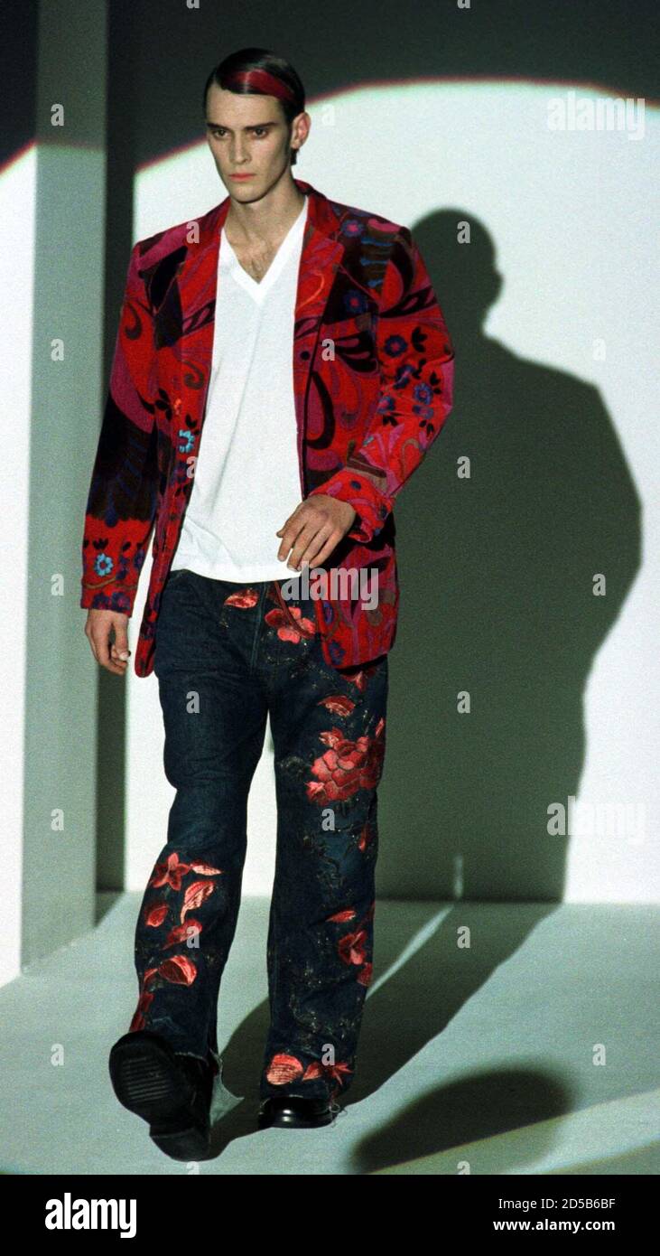 A model wears a floral jacket and trouser suit as part of the Gucci  collection during the autumn/winter 1999/2000 men's fashion show January  10. Milan's fashion show will run until January 13