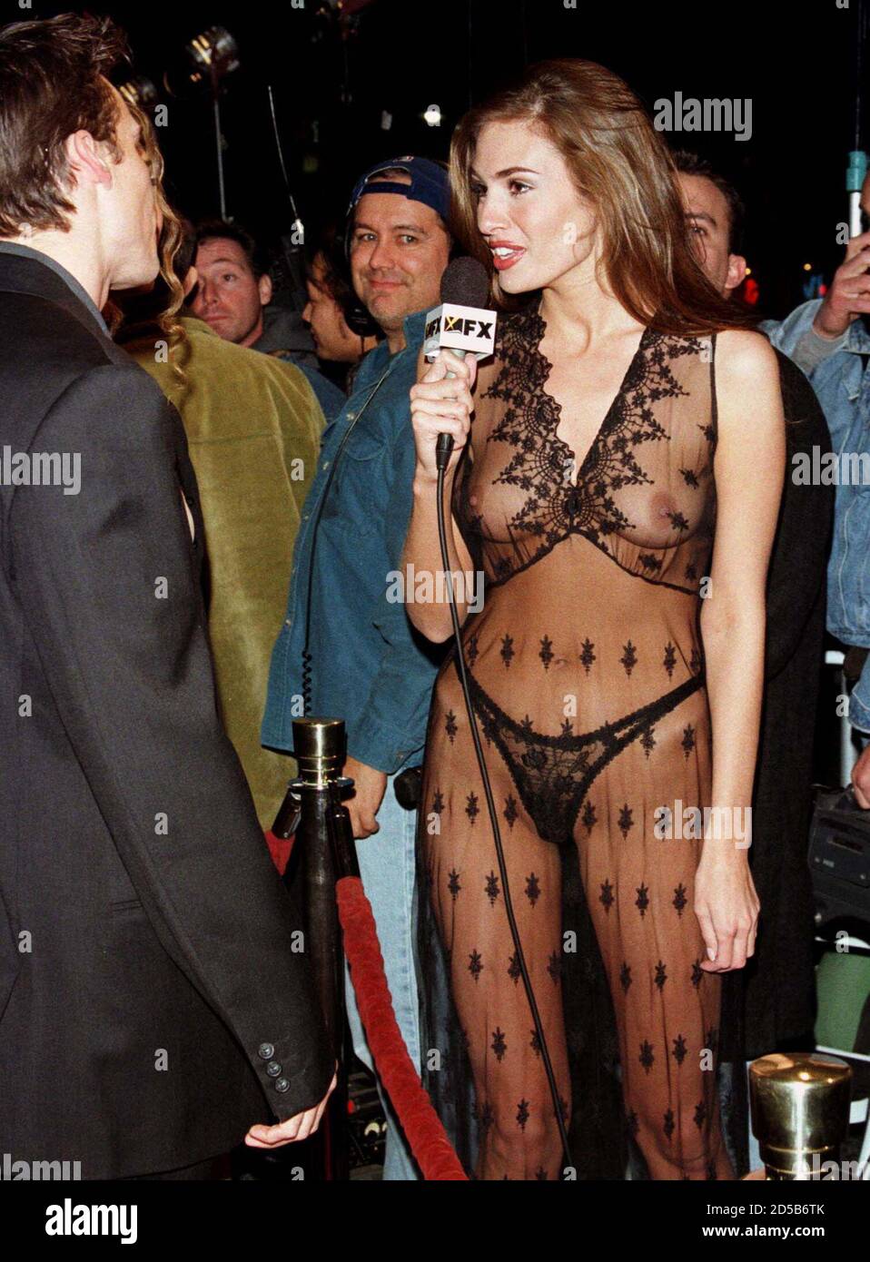 Ashley, a reporter for the cable television channel FX, wears a sheer outfit as she interviews an unidentified celebrity at the premiere of the  new comedy film 'Jawbreaker' February 11 in Hollywood. [The film is a parody of the high school comedy and horror films of the past 20 years and follows the exploits of a clique of girls at a Los Angeles area high school. The film opens in the United States February 19.  ] Stock Photo
