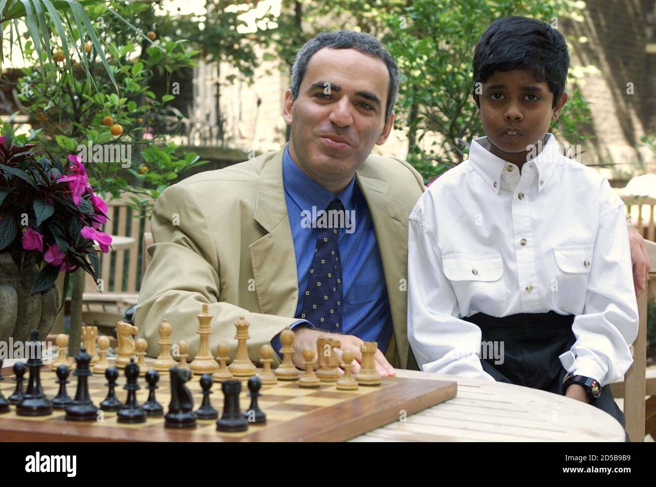 World chess champion Garry Kasparov poses for photographers with Murugan  Thiruchelvam, age 10, of New Malden after a news conference September 2.  Kasparov recommended Thiruchelvam, who is one of Britain's brightest chess