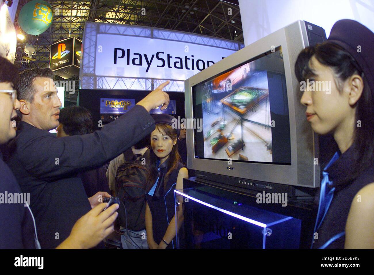 A western visitor looks at the new version of Sony's game machine PlayStation  2 displayed at Tokyo Game Show in Makuhari September 17. Sony unveiled the  new PlayStation this week which will