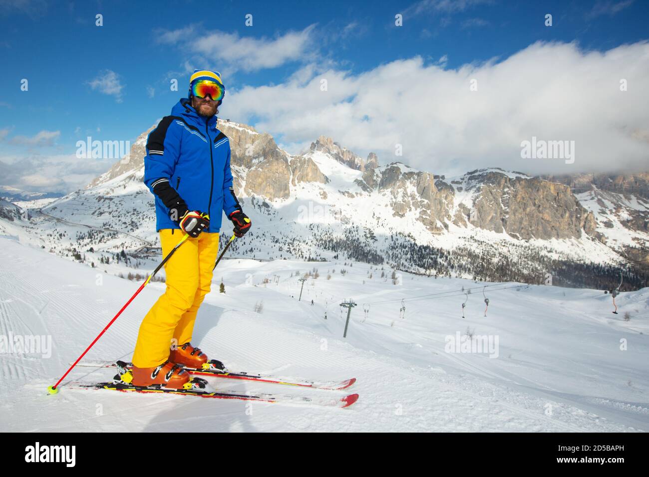 Alpine skier stand on slope in winter mountains Dolomites Italy in beautiful alps Cortina d'Ampezzo Col Gallina mountain peaks famous landscape skiing Stock Photo