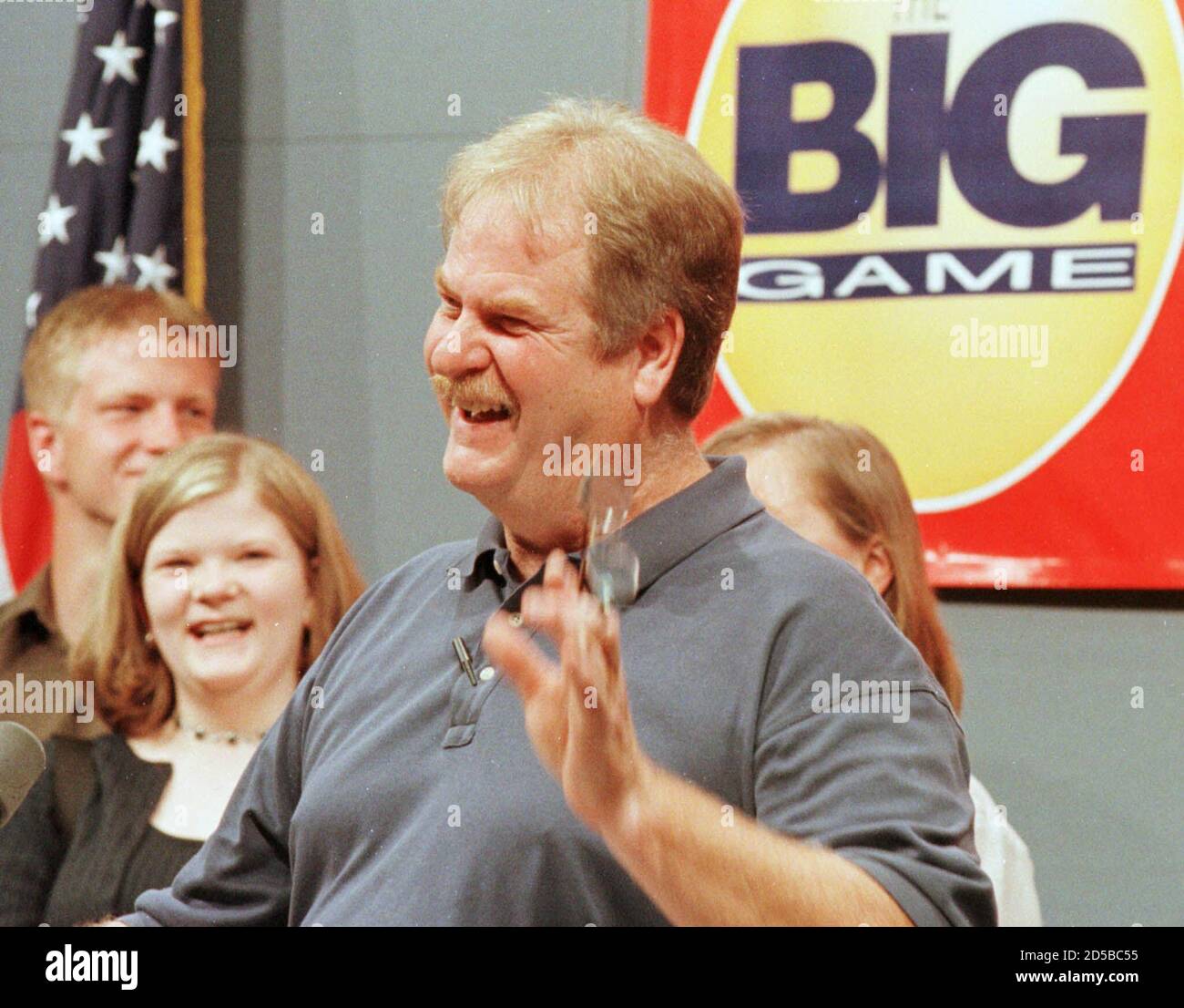 Larry Ross, with his family behind him, answers questions at a May 12 press conference at a state building in Lansing where he claimed his share of the largest lottery jackpot in North America to date. Ross said he bought a hot dog at a local store with a hundred dollar bill and took his change in lottery tickets, resulting in the winning ticket. The Rosses chose the cash option for their share of the prize winnings, $181.5 million, allowing him to collect a one-time prize payment of approximately $60 million after taxes.  RC/HB Stock Photo