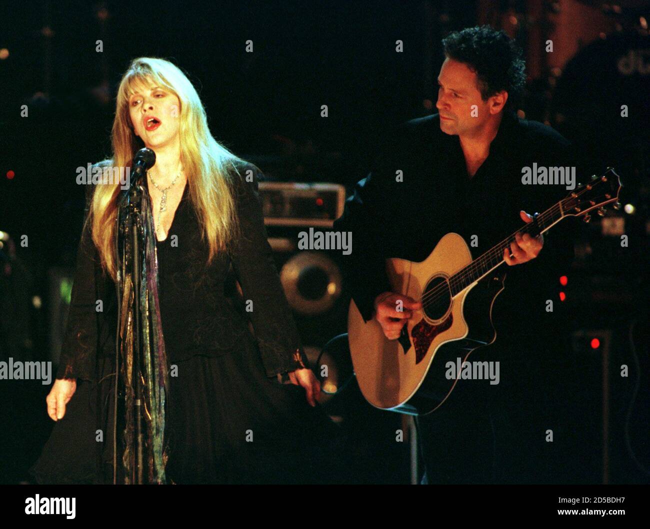 Stevie Nicks (L) and Lindsey Buckingham of the band Fleetwood Mac perform  on stage after the band was inducted into the Rock and Roll Hall of Fame at  the Rock and Roll