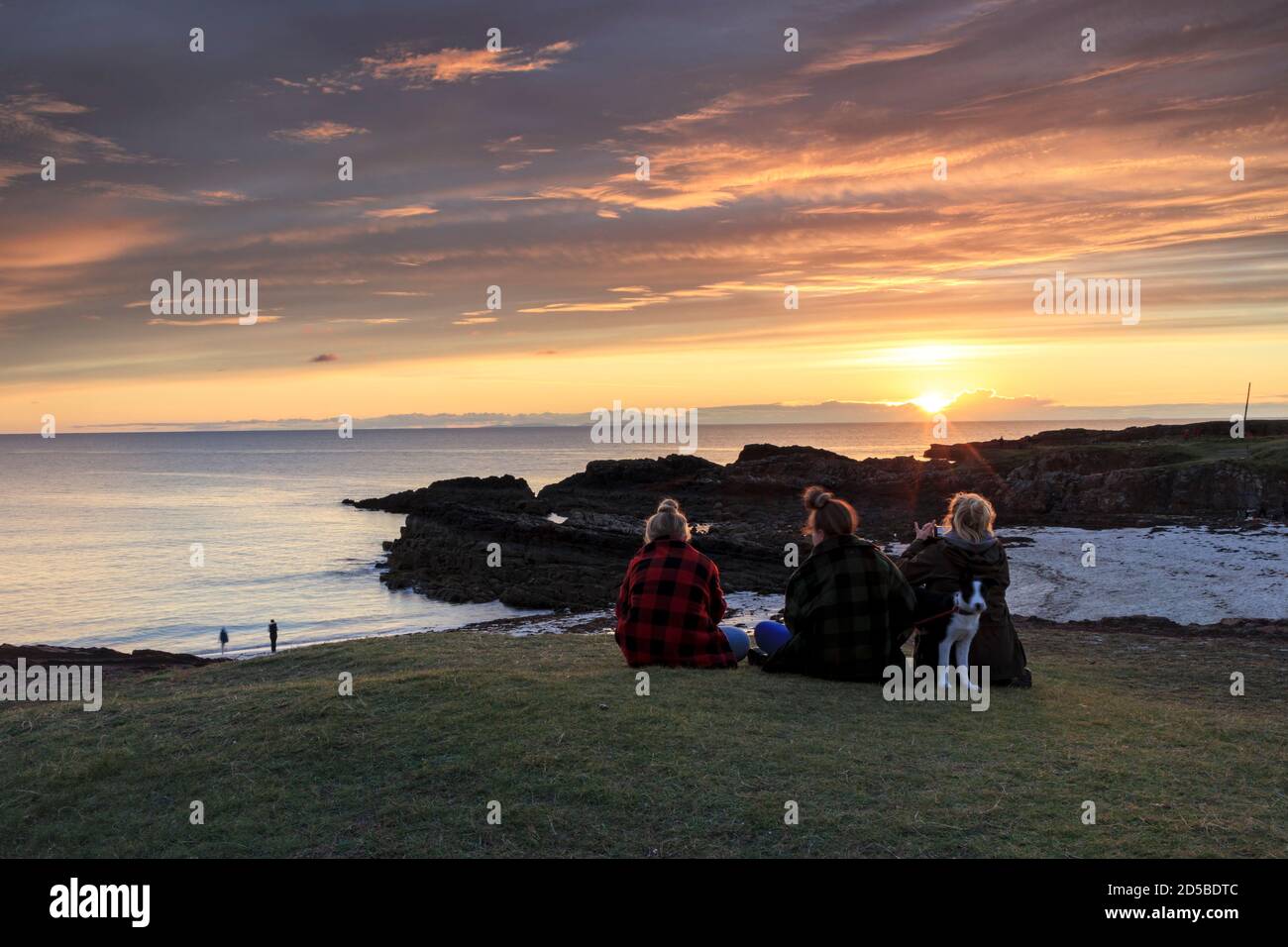 People Watching the Sunset over Clachtoll Bay, NW Highlands of Scotland, UK Stock Photo