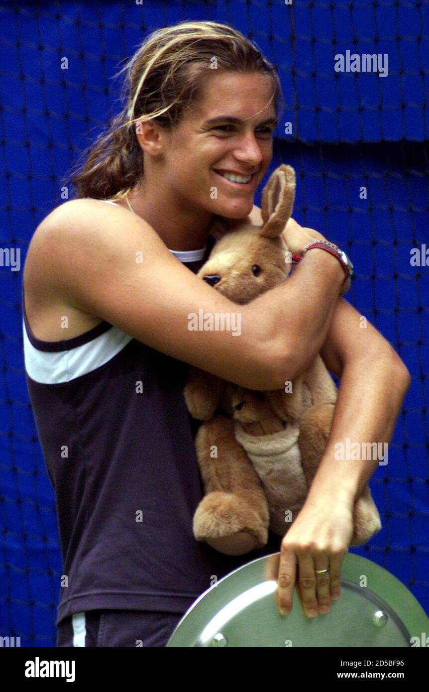 Amelie Mauresmo of France hugs a kangaroo mascot she received during
