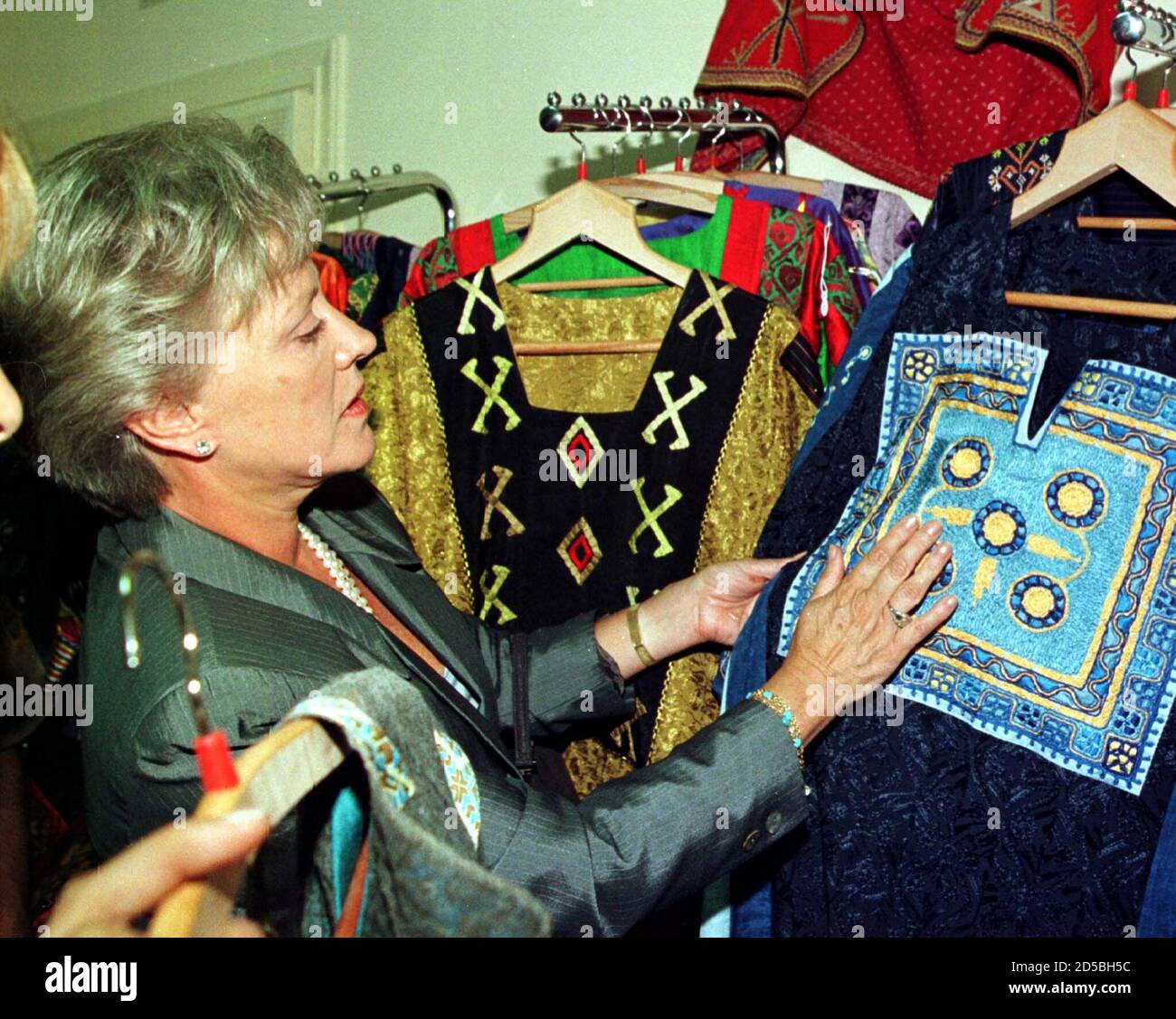 British-born Princess Mona, the former Toni Gardner, Jordanian King  Abdullah's mother and ex-wife of the late King Hussein looks at Arabian  dresses at the opening ceremony of Bader Al Duja for Arabian