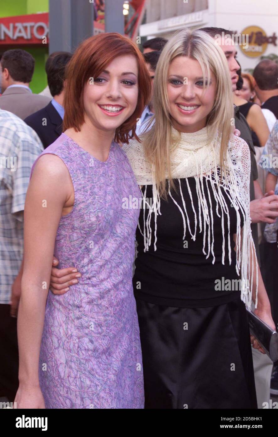 Actresses Alyson Hannigan (L) and Tara Reid, two of the ensemble cast members of the comedy film ' American Pie' arrive for the film's premiere July 7 in Los Angeles. The film opens July 9 in the United States explores a group of teenagers and their quest to lose their virginity.  FSP Stock Photo