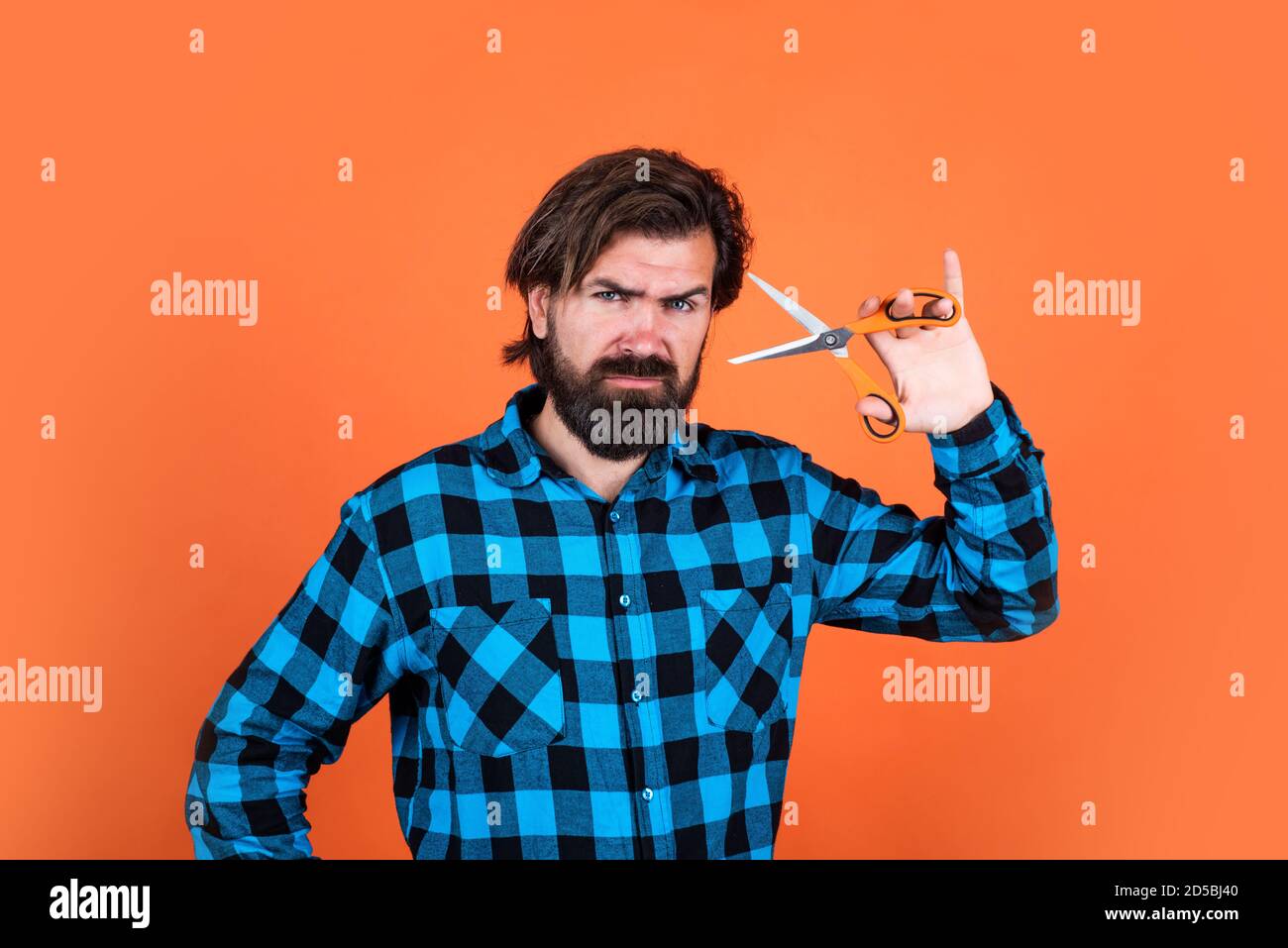 bearded hipster cut his beard and moustache. barber use