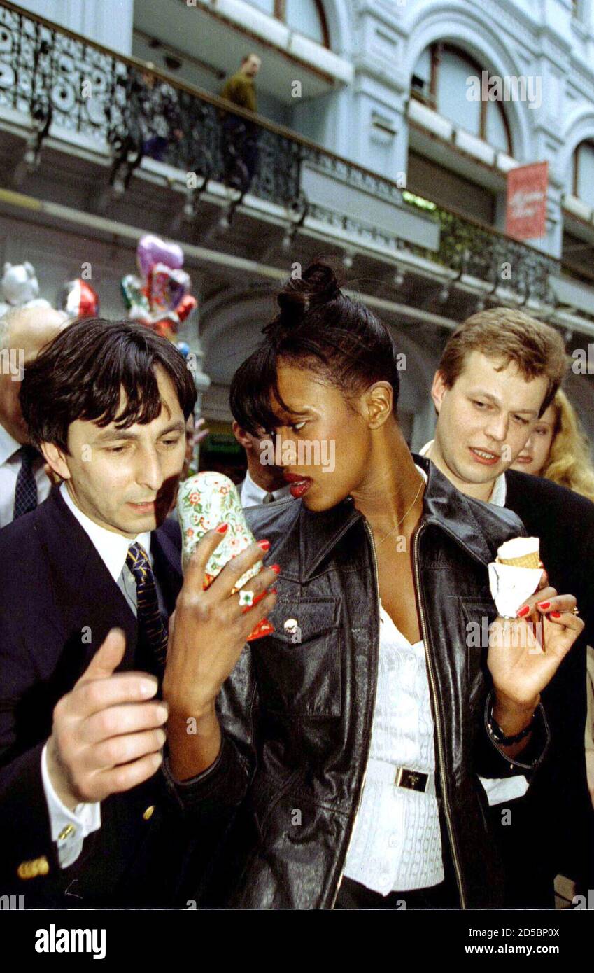 British top model Naomi Campbell discusses a Matryoshka doll at Russia's  GUM supermarket as she takes a stroll in Red Square in Moscow on April 21.  Campbell takes part in a fashion