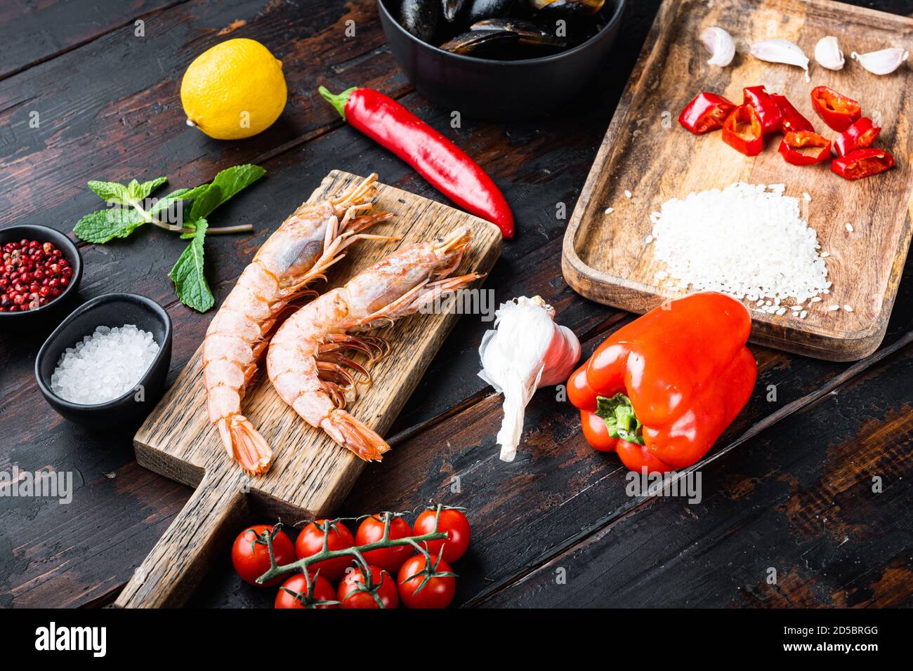 Traditional spanish seafood paella ingredients on old wooden dark table Stock Photo