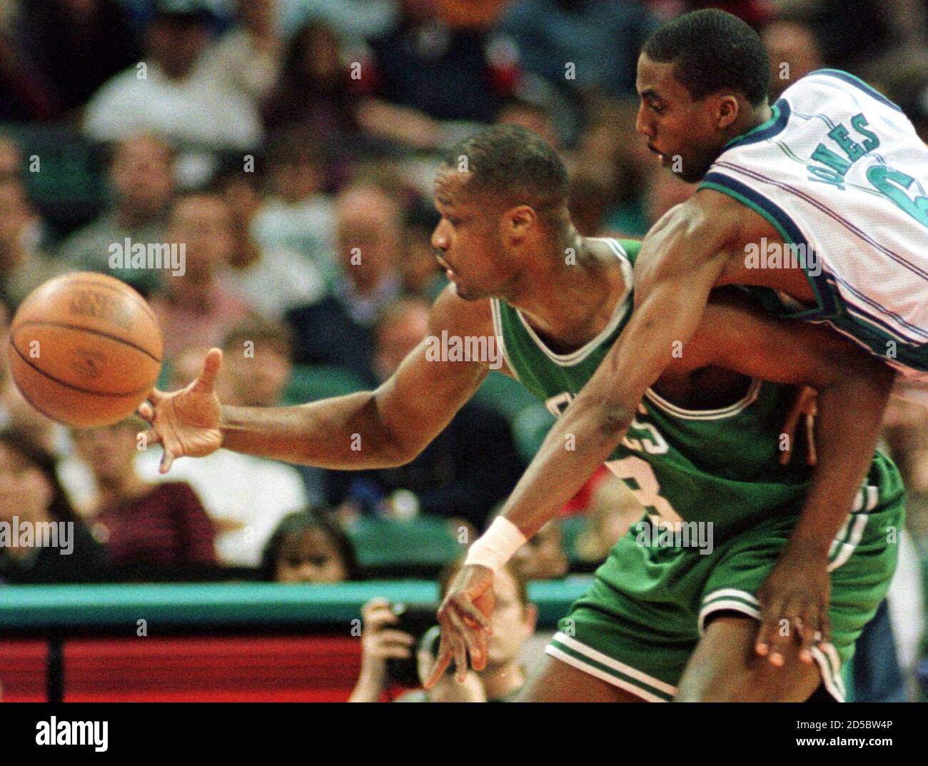 Charlotte Hornets' guard Eddie Jones (R) knocks the ball loose from Boston  Celtics' forward Antoine Walker (L), March 30 during first half NBA action  at the Charlotte Coliseum. RDP/HB/CC Stock Photo -