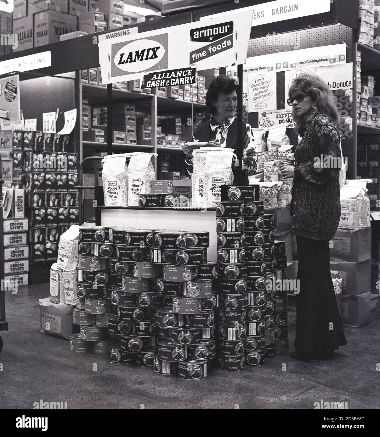 1970s, historical, lady standing at the counter of a display of bulk