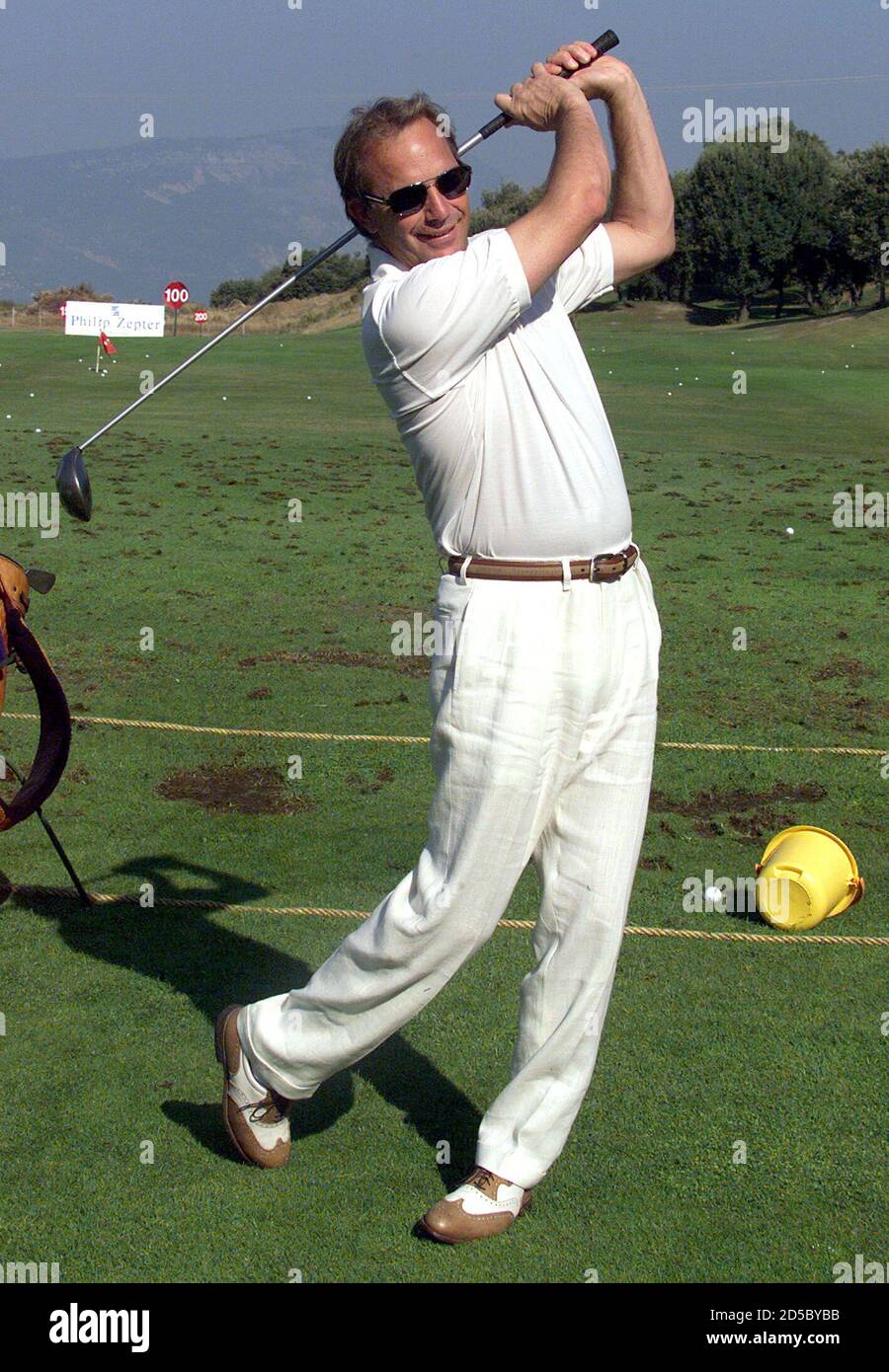 American actor Kevin Costner takes a warm-up swing before the pro-celebrity  golf tournament at