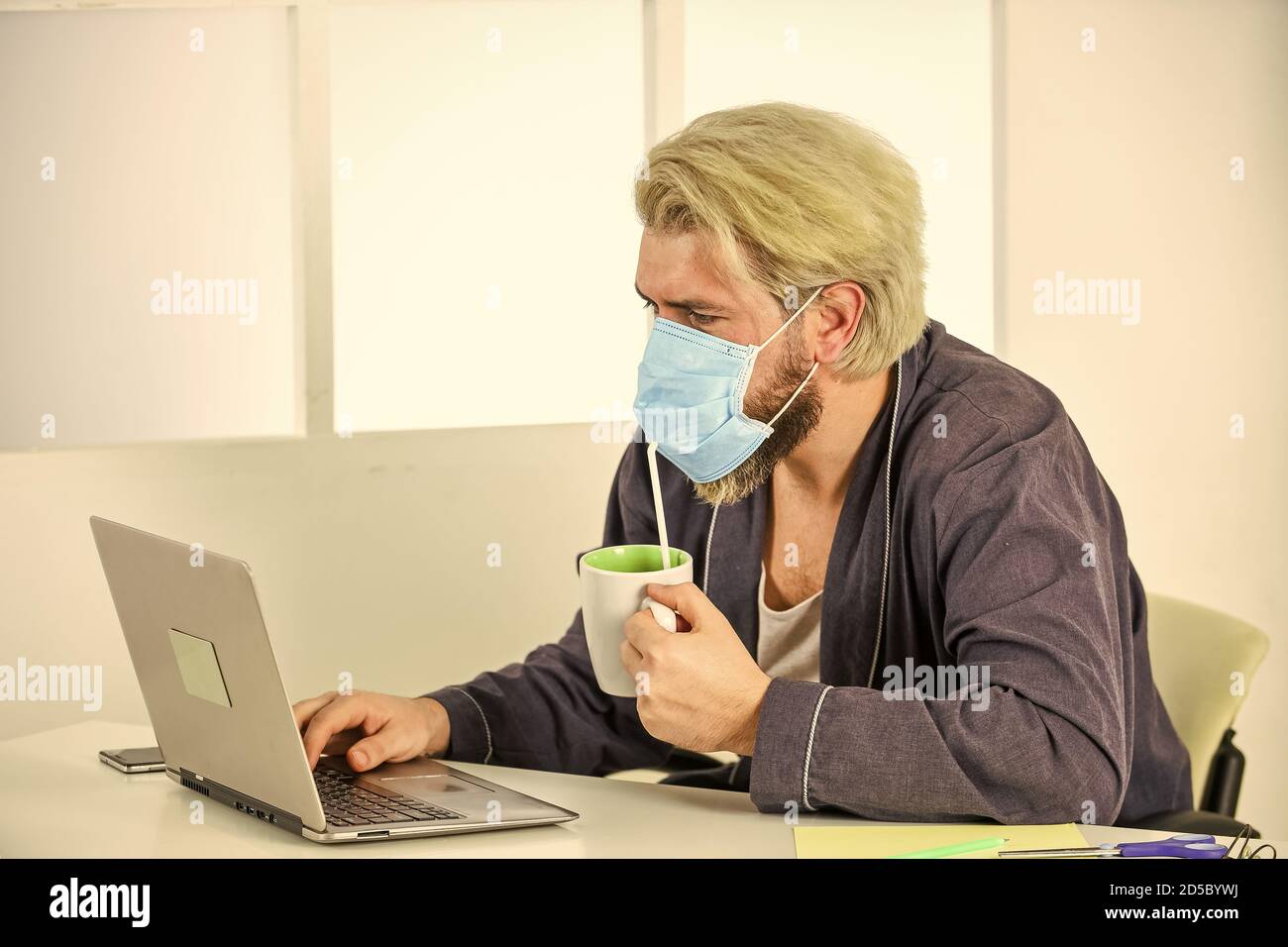 remote-based job. online shopping. man in respirator protective mask in office. work on a remote site. distance learning. infection control and prevention measures. keep your distance. Stock Photo