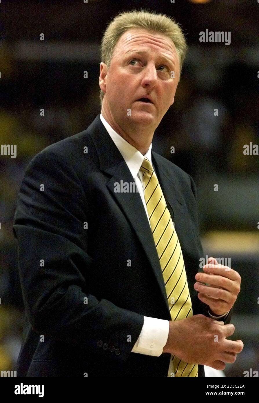 Indiana Pacers head coach Larry Bird glances at the scoreboard as he walks  off the court at the end of the first quarter in Game 6 of the NBA Finals  against the