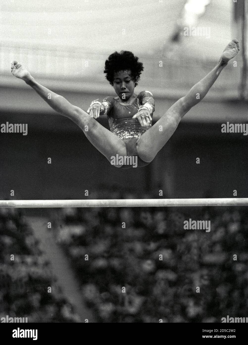 Indonesia's Woro Endang Werdiningsih leaps backwards as she catches the bar during her routine on the uneven bars September 22, 1986 at the women's gymnastics team event of the Asian Games in Seoul. SCANNED FROM NEGATIVE. REUTERS/Shunsuke Akatsuka  GDB/CMC/PN Stock Photo