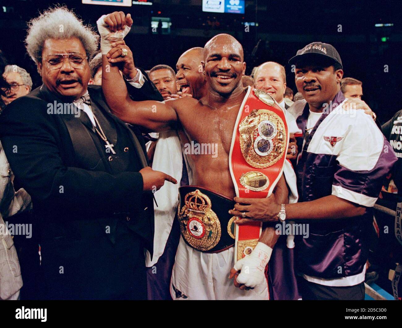 WBA Heavyweight Champion Evander Holyfield shows his IBF and WBA Heavyweight belts, after defeating Michael Moorer Heavyweight title fight November 8 in Las Vegas. Evander Holyfield won the Boxing