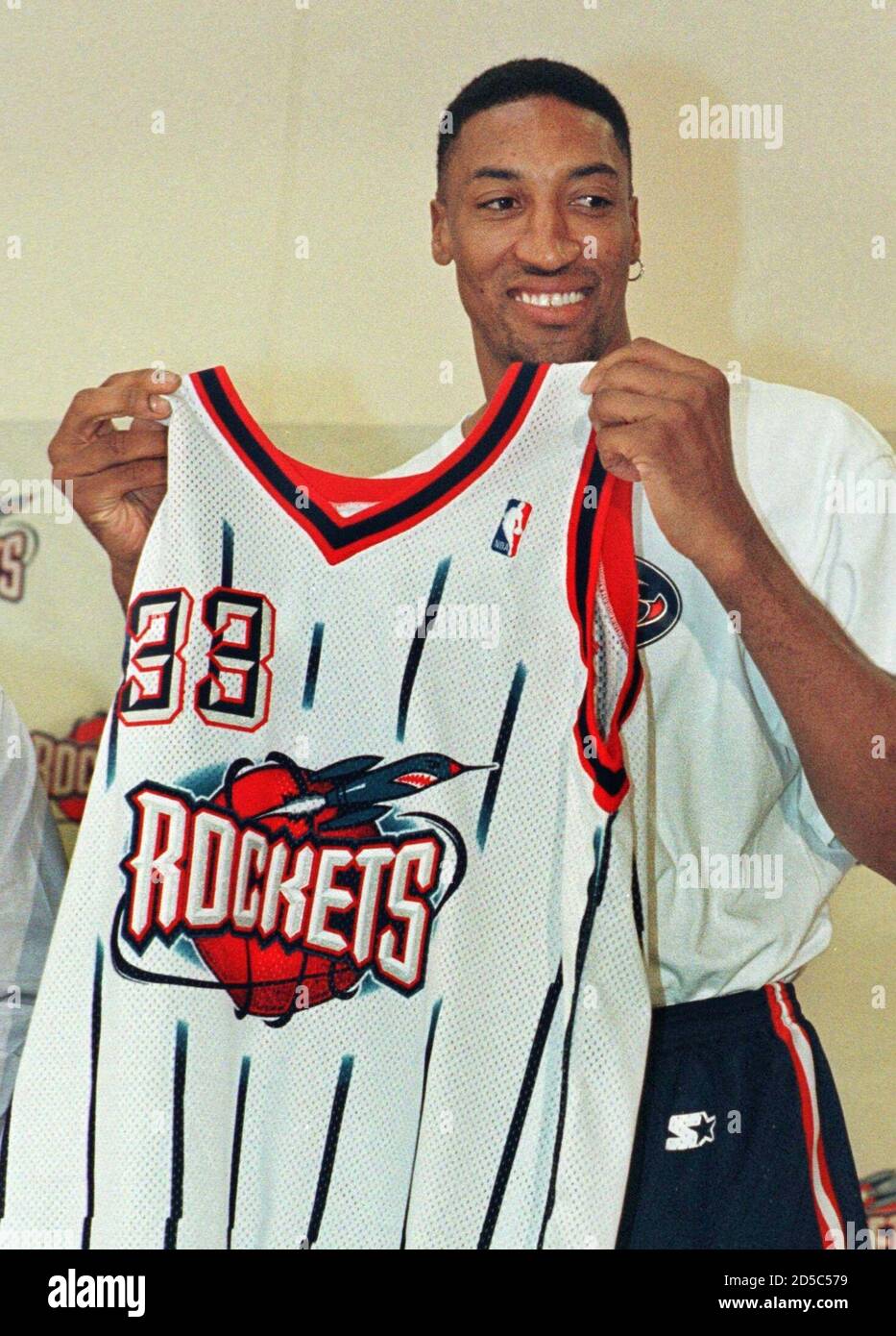 Former Chicago Bulls forward Scottie Pippen holds up his new jersey after  officially being traded to the Houston Rockets, January 22. Pippen, who was  acquired from the Chicago Bulls in exchange for