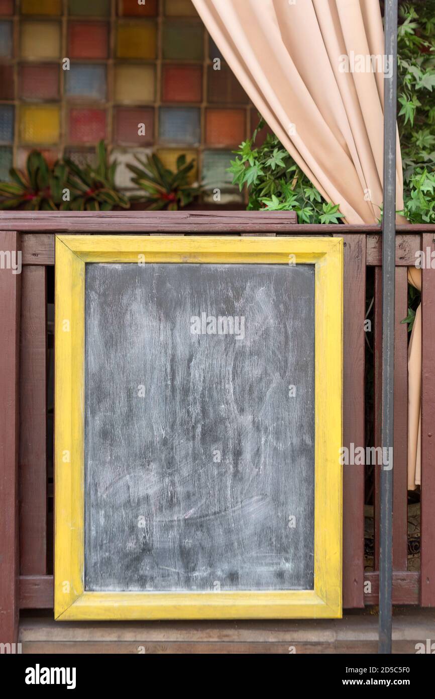 Signboard on the street. Empty menu board stand. Restaurant sidewalk chalkboard sign board