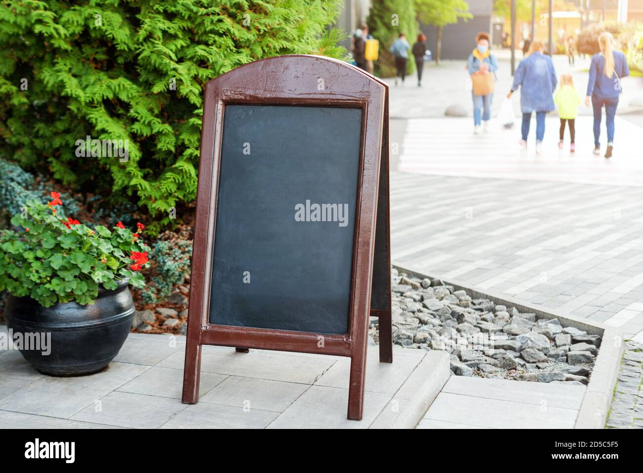 Signboard on the street. Empty menu board stand. Restaurant sidewalk chalkboard sign board