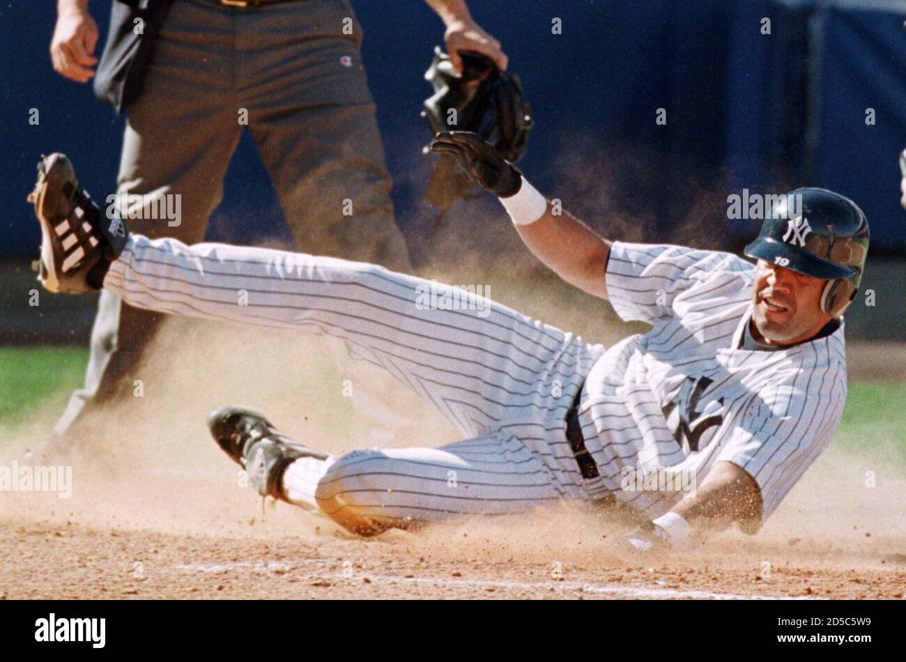New York Yankees Infielder Luis Sojo Of Barquisimento Venezuela Slides Safely Into Home To Score Against The Toronto Blue Jays In The Seventh Inning Of His Club S Spring Training Opener Against The