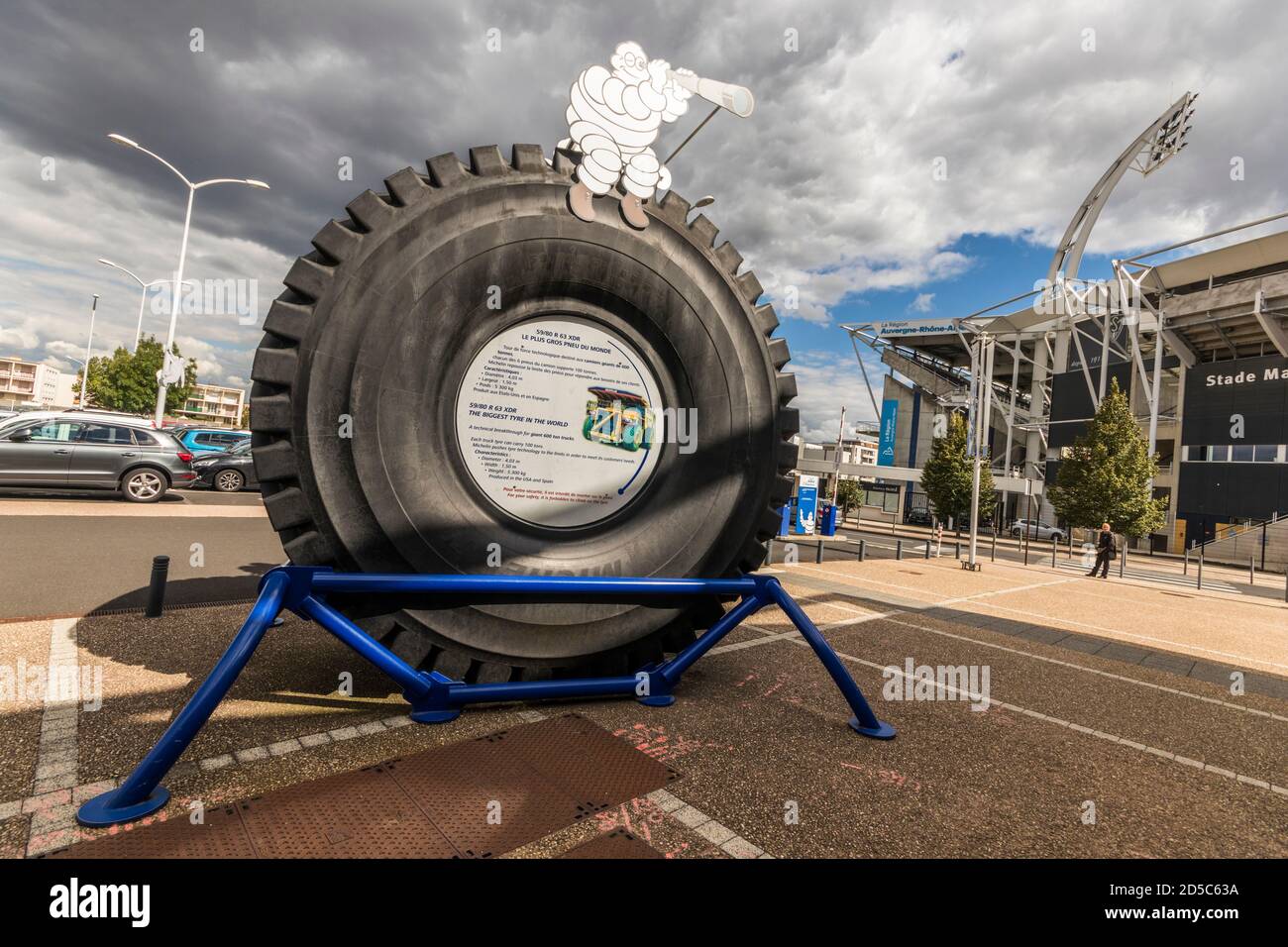 Clermont-Ferrand, France. Figure of Bibendum (Michelin Tyre Man), at the L'Aventure Michelin museum over the largest tyre in the world Stock Photo