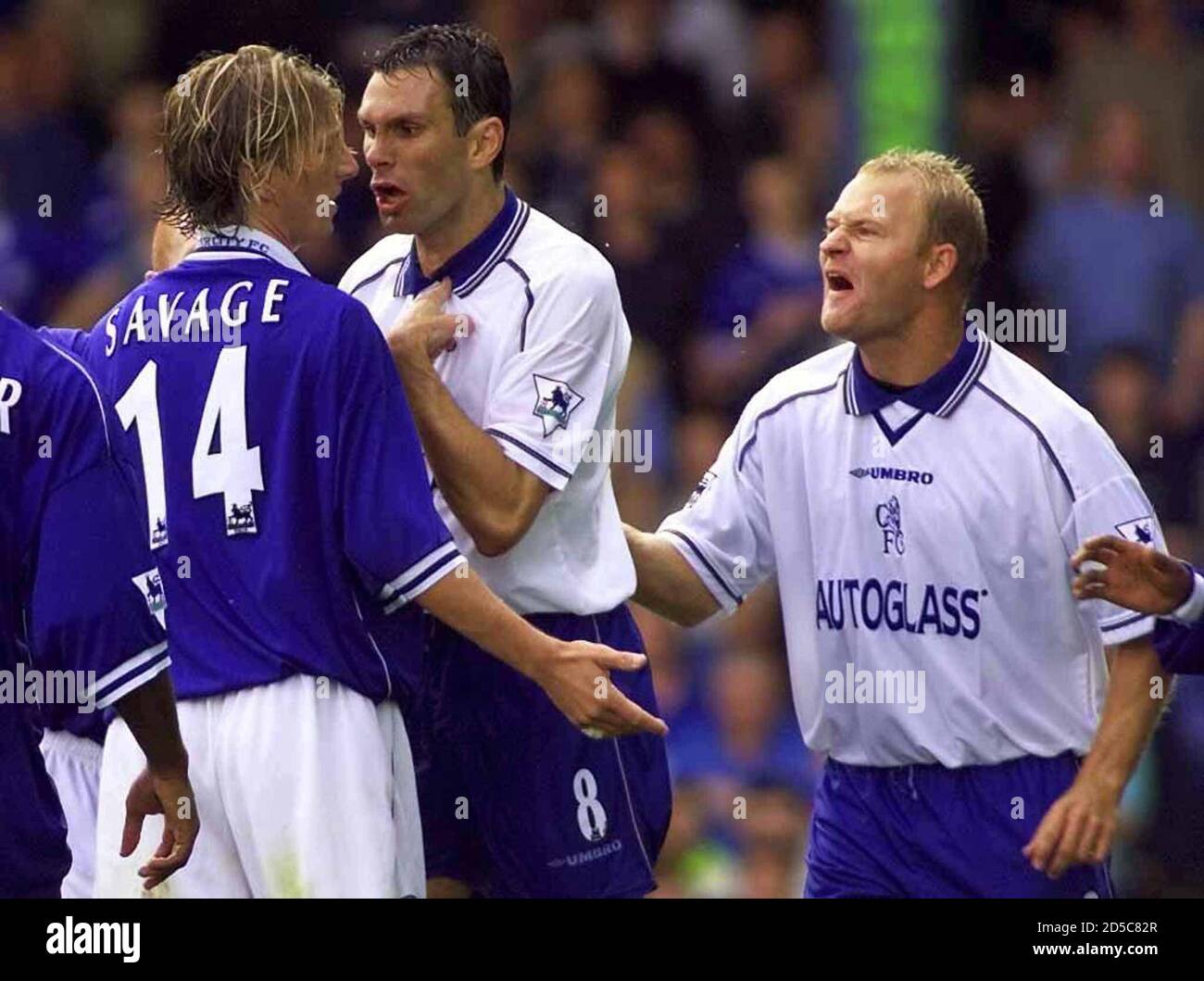 Chelsea S Gustavo Poyet C Of Uruguay And Danish Midfielder Bjarne Goldbaek R Confront Leicester City S Robbie Savage L After A Tackle At Filbert Street August 14 The Premier League Match Finished 2 2