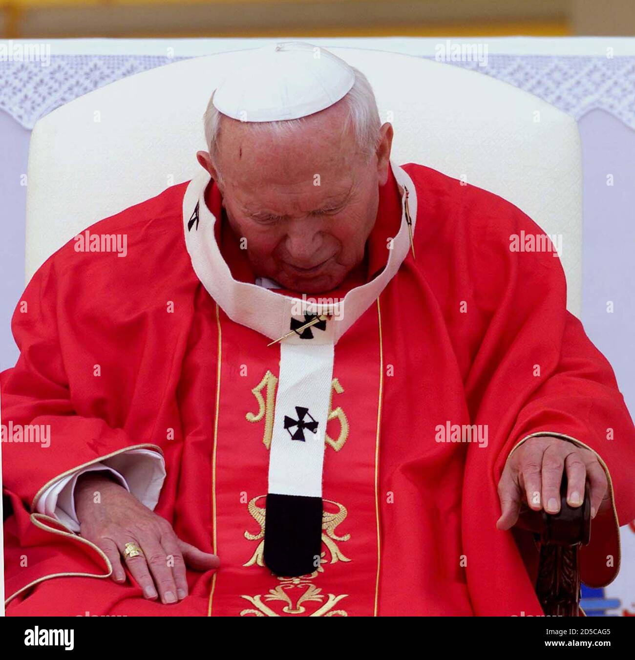 Pope John Paul II looks tired infront of the altar under a canopy in the  Vatican's yellow and white colours, at Amman's Al Hussein stadium to  celebrate the holy mass, March 21.