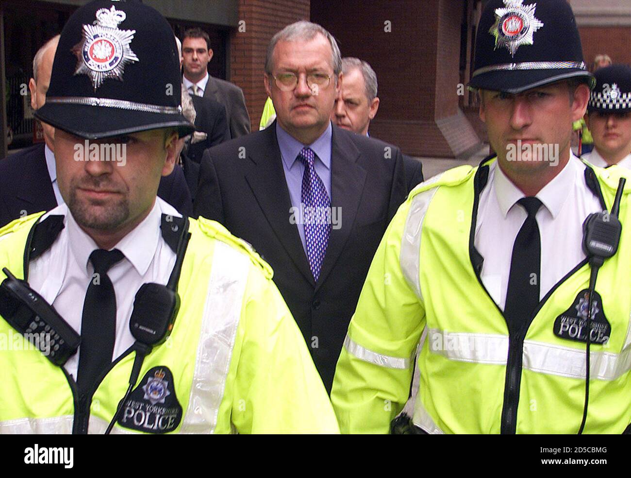 Former South Yorkshire Police Chief Superintendent David Duckinfield leaves court under police escort after the jury failed to reach a verdict at Leeds Crown Court July 24, 2000. Former Chief Superintendant David Duckinfield was charged with manslaughter and wilful neglect of duty in the first criminal proceedings to follow the Hillsborough tragedy in which 96 Liverpool soccer fans were crushed to death at the 1989 FA Cup Semi final.  DC/JDP Stock Photo