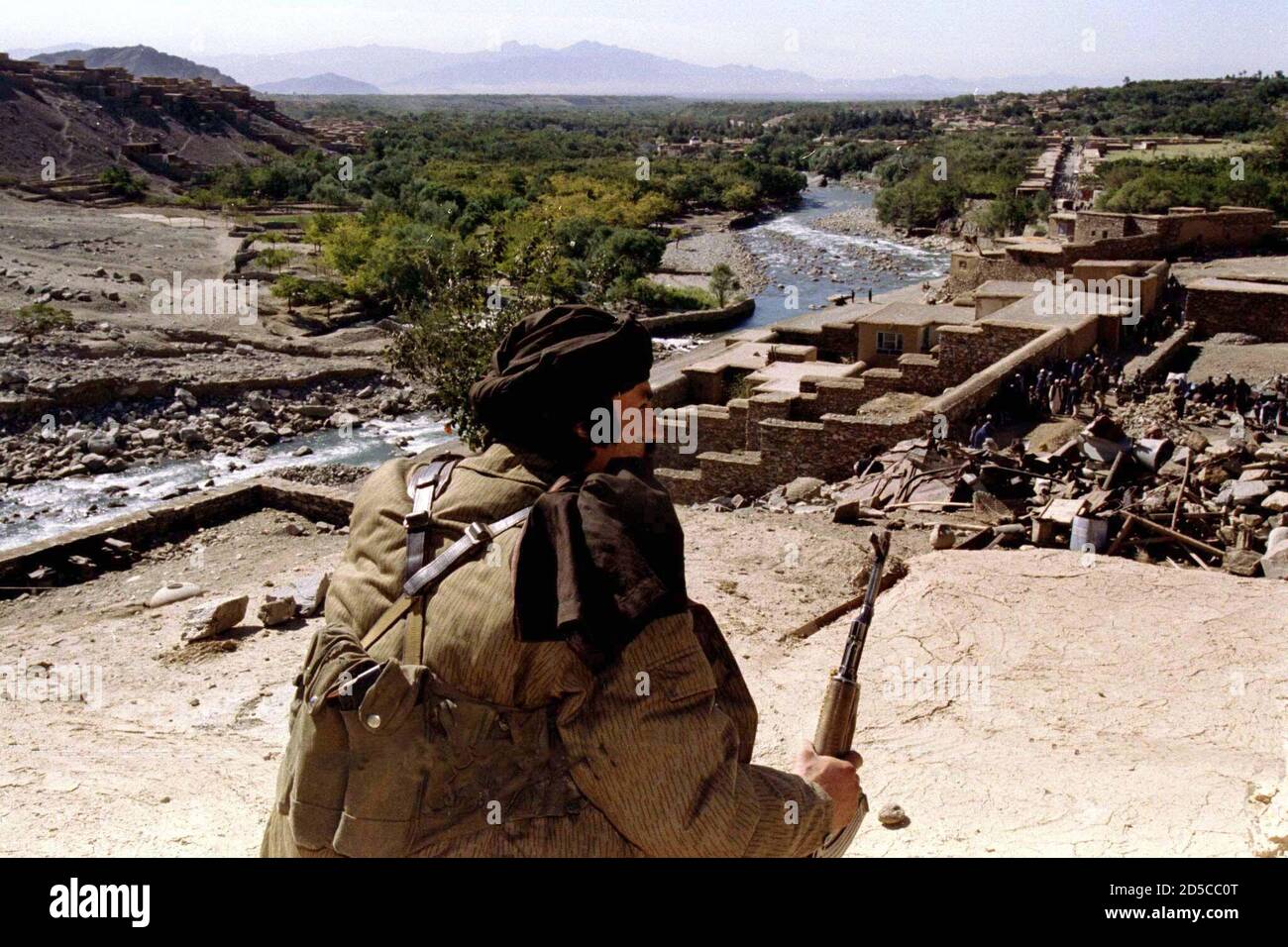An ethnic Tajik fighter guards the entrance of the Panjshir Valley, north of Kabul as displaced Afghan people prepare to leave the valley October 3. Fighters loyal to famed guerrilla chief [Ahmad Shah Masood ] work to prepare the defence of their valley against an expected assault by Afghanisatn's hardline Islamist Taliban militia. Stock Photo