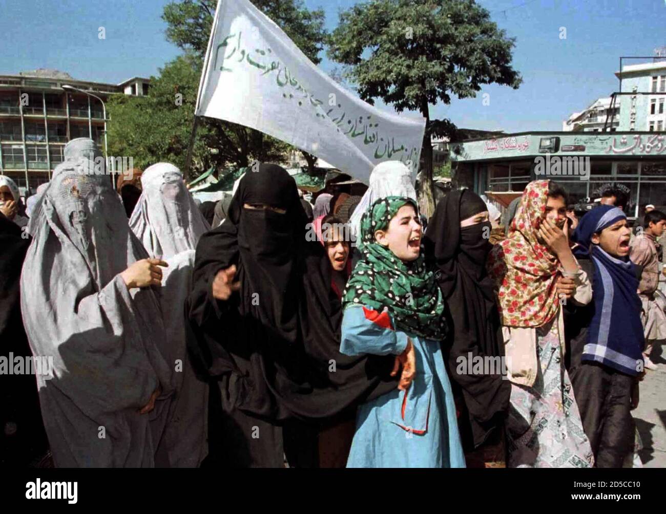 Afghan women, most of them civil servants, march through the Afghan capital, October 17. A few thousand demonstrators protested against what Taliban calls interference [of Iran, Russia and India in Afghan affairs]. The banner reads 'We Muslim women of Afghanistan hate to be indecent. Stock Photo