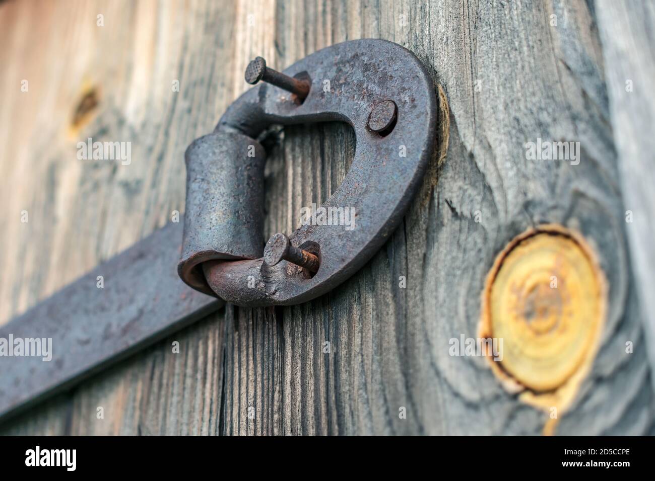 Rusty door hinge with pulled out nails on old wooden doors Stock Photo Alamy