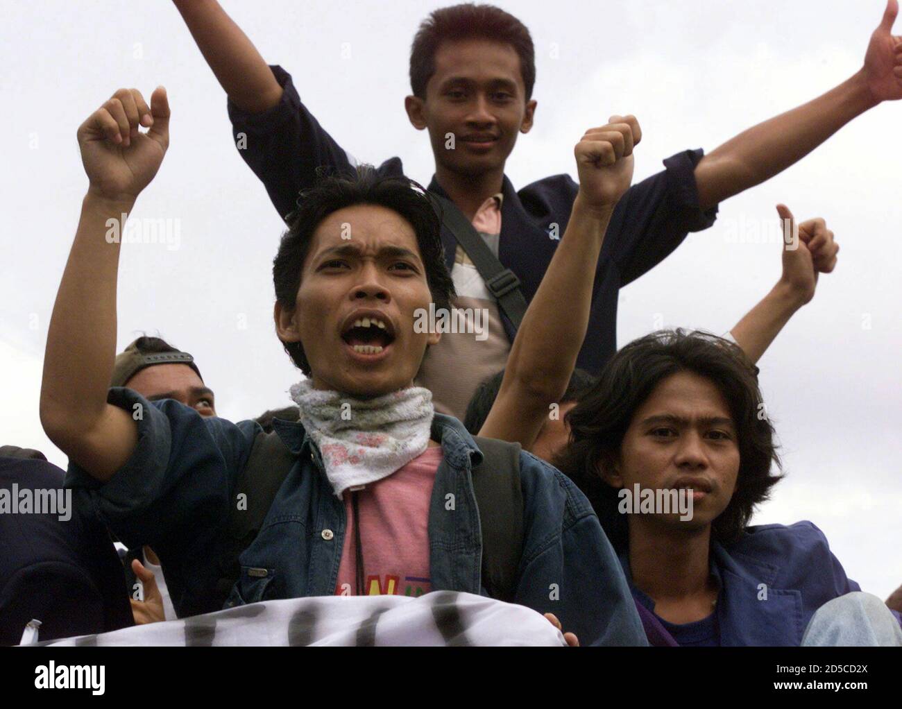 Indonesian students shout slogans as they ride on a bus through central Jakarta November 21. Anti-government protests have failed to gain momentum since Friday as the city stayed quiet and ousted [President Suharto] went fishing. **DIGITAL IMAGE** Stock Photo