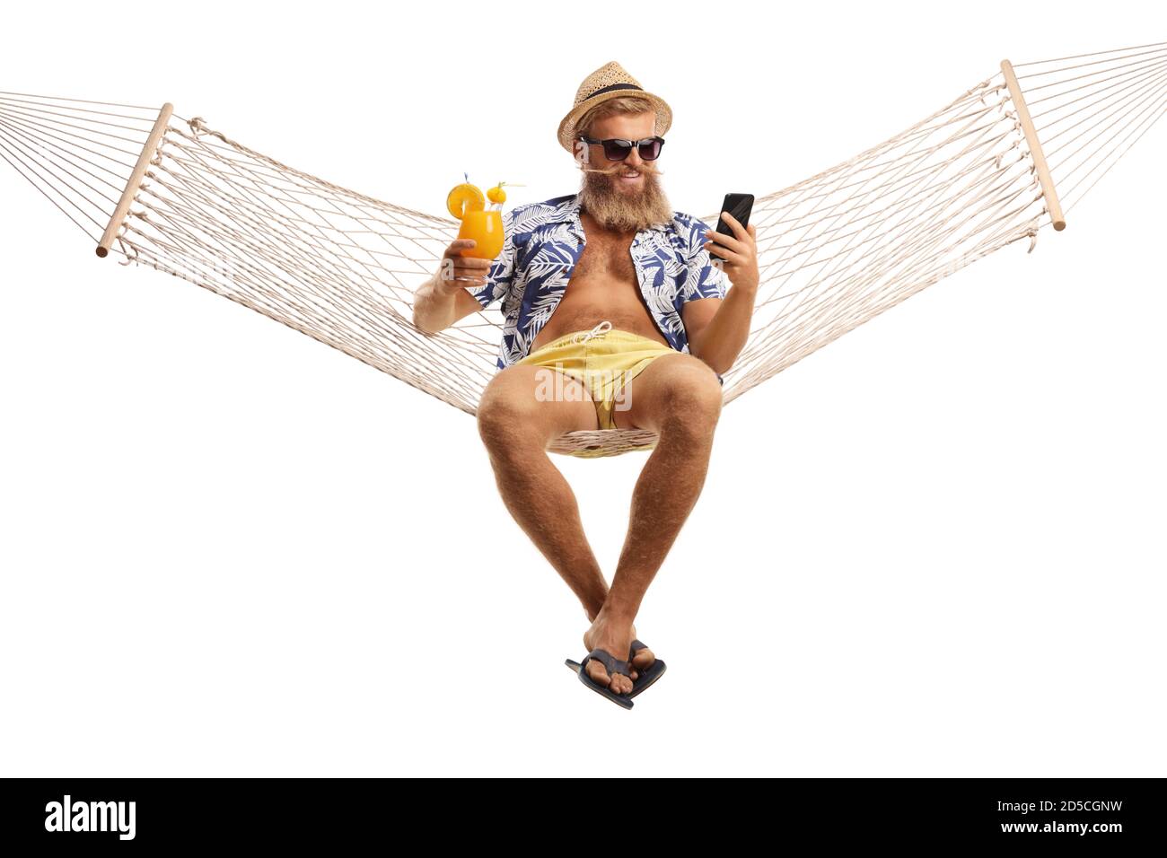 Bearded guy with sunglasses sitting in a hammock with a cocktail and a mobile phone isolated on white background Stock Photo