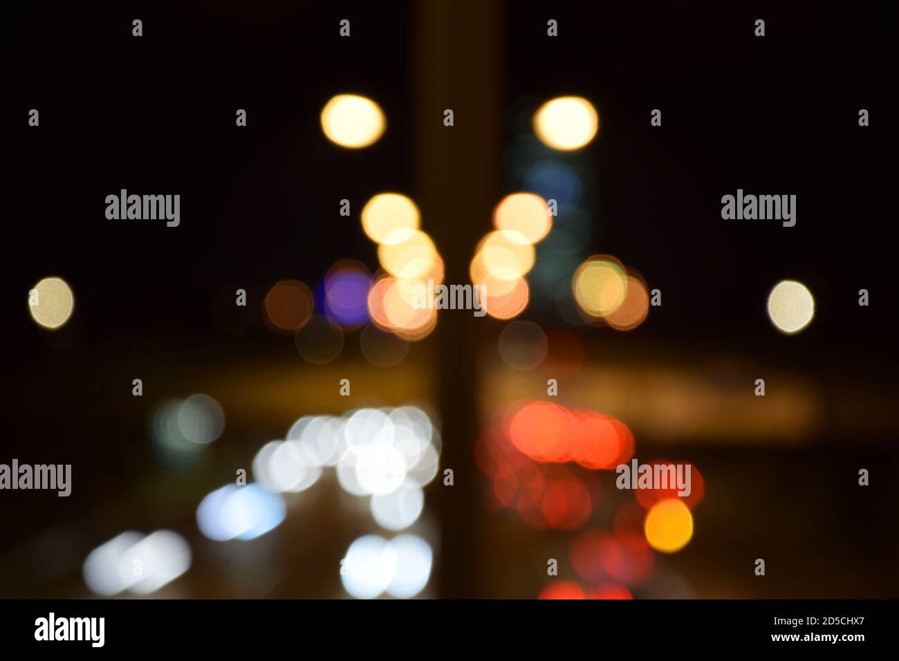 Blurred traffic lights at night. Blurry city lights at night. Bokeh