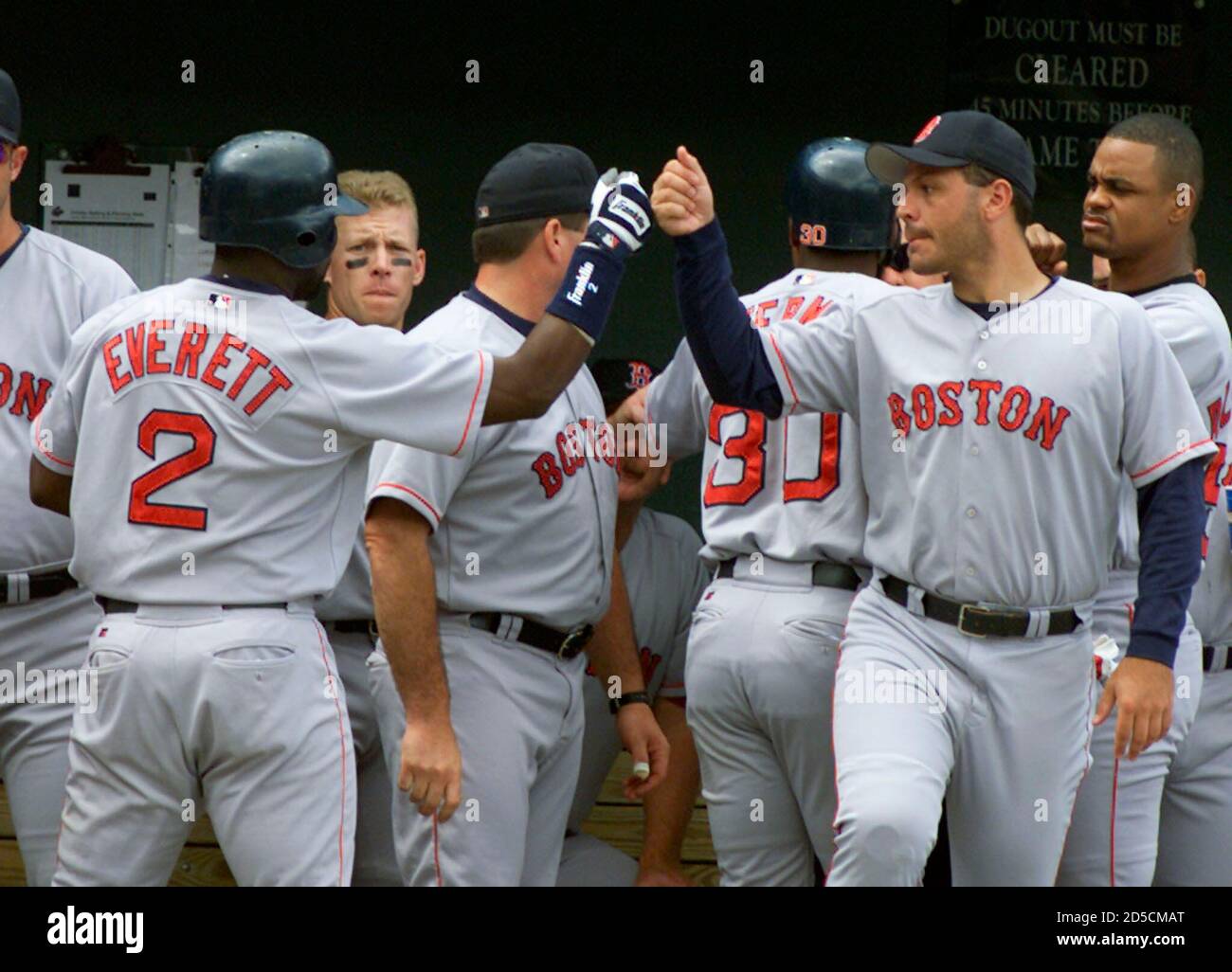 Boston Red Sox Carl Everett (2) is greeted by his teammates in the dugout  at Camden Yards following his two-run homer off Baltimore Orioles' Sidney  Ponson in the first inning of the