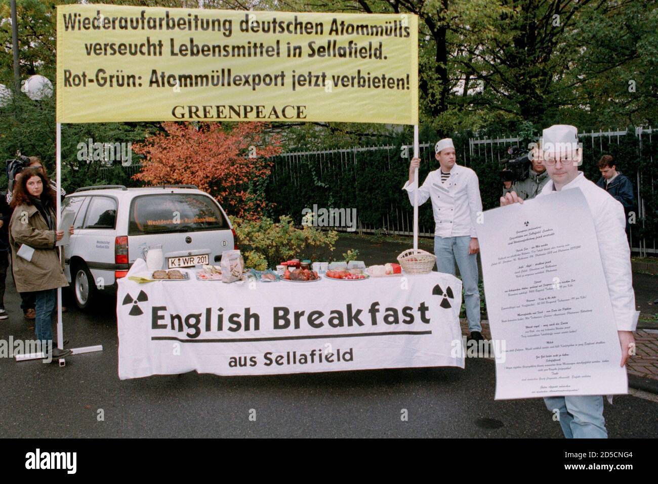 Members of the environmental group Greenpeace dressed as cooks present a  buffet of food near the British nuclear reprocessing plant Sellafield,  prior to the fourth round of coalition talks between the German