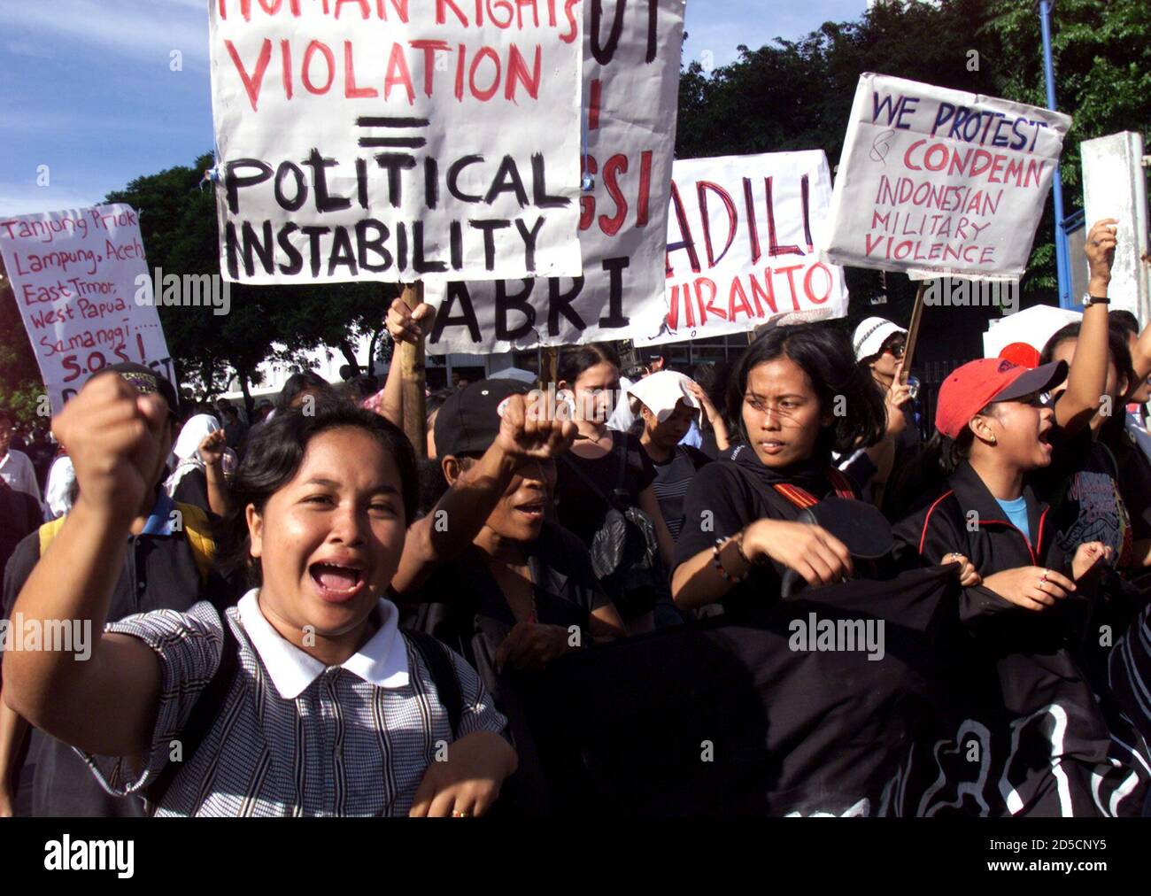 Indonesian protesters carry banners as they demonstrate in central Jakarta November 20. Indonesia was braced for fresh anti-government protests after ceremonies to mourn the students killed a week ago in violent clashes with the military and officials said former [President Suharto] had left the city.  ??» Stock Photo