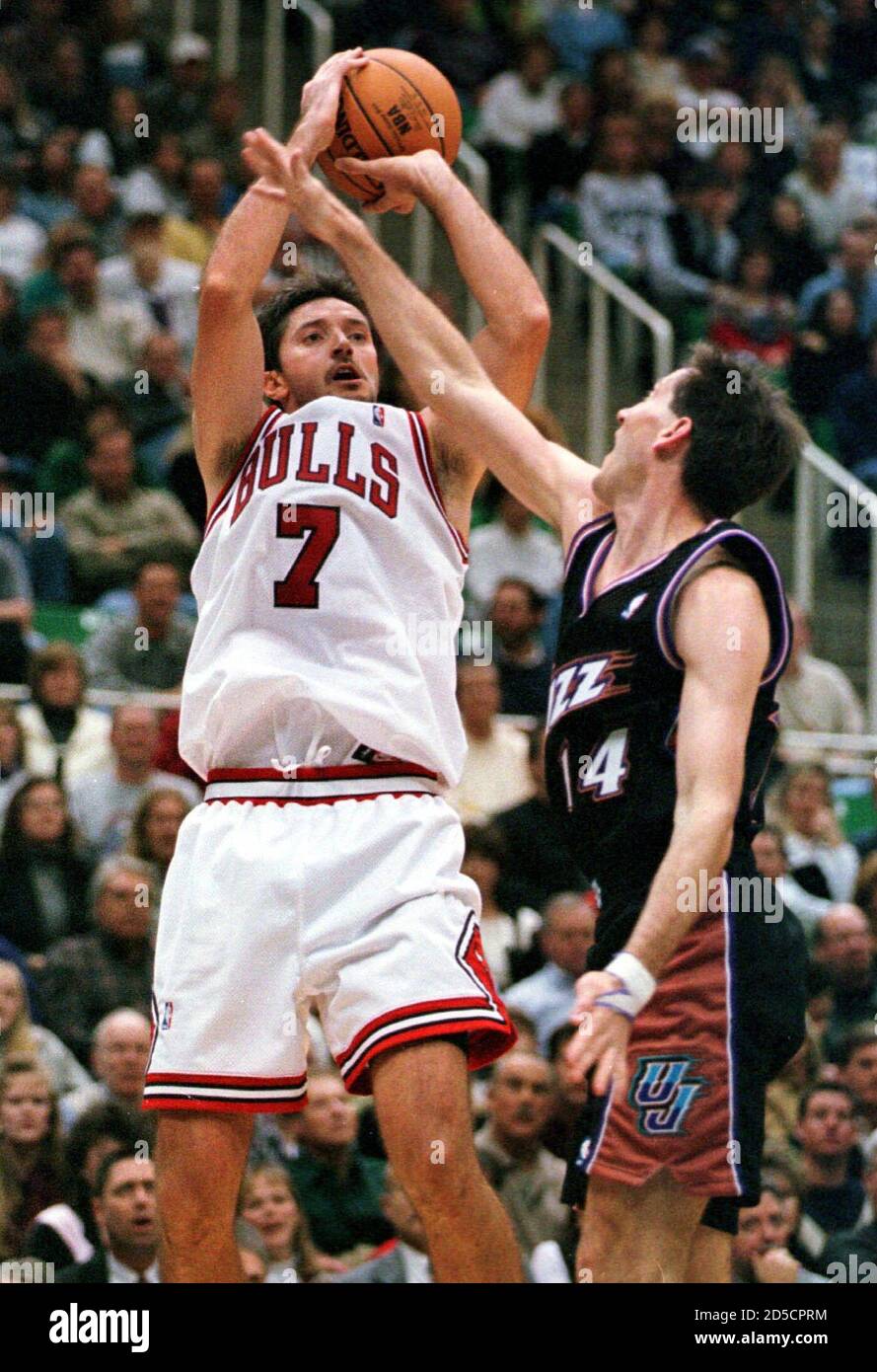 Chicago Bulls forward Tony Kukoc (L) puts up a three-pointer over Utah Jazz guard Jeff Hornacek during the fourth quarter of the season opener February 5. Kukoc finished with a game-high 32 points, but the Jazz beat the Bulls 104-96. scw/Photo by Steve C.  SW/RC/JDP Stock Photo