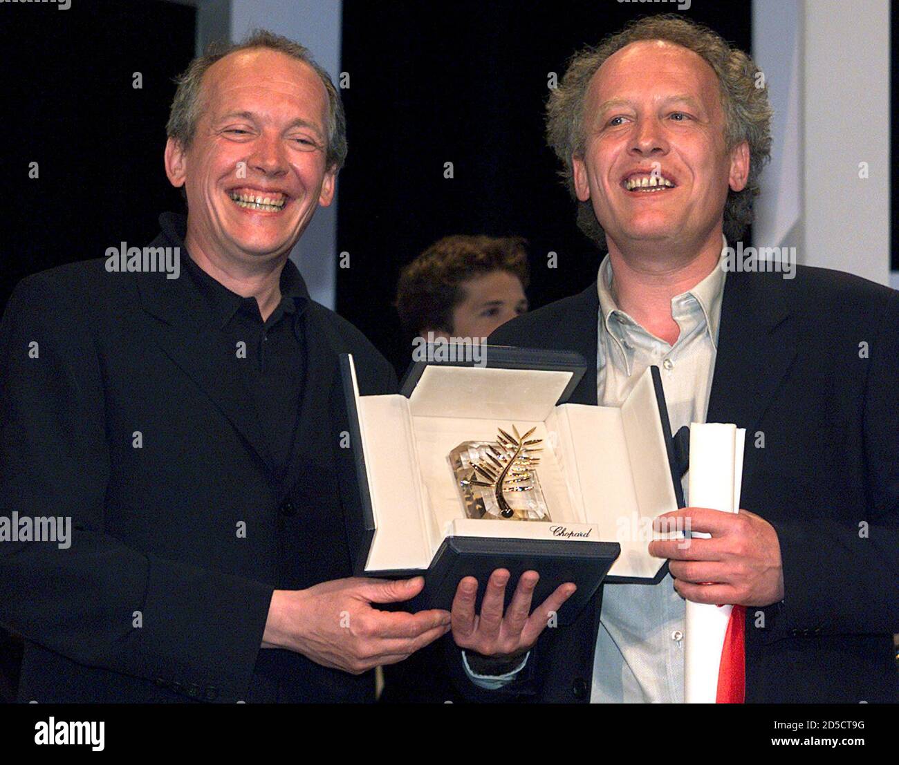 Belgian directors Luc (L) and Jean-Pierre (R) Dardenne smile as they hold  their Palme d'Or for their film "Rosetta" during the closing ceremonies at  the 52nd Cannes Film Festival May 23. Belgian