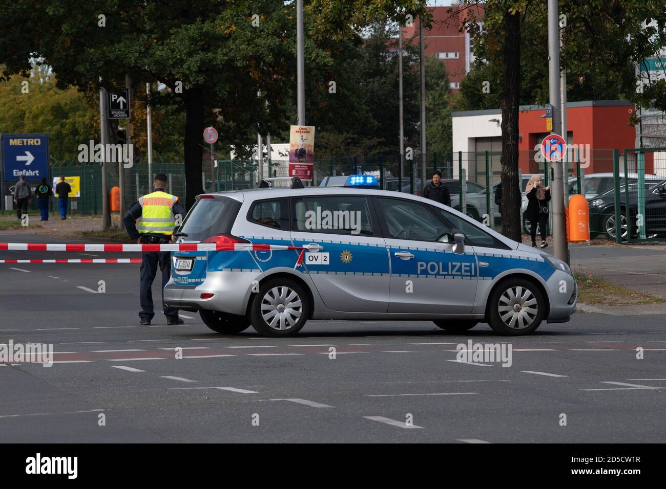 Berlin, Germany. 13th Oct, 2020. A police car is parked across the Nonnendammallee in the Berlin district of Haselhorst. There a bomb from the Second World War was defused near Ferdinand-Friedensburg-Platz. The police set up a restricted area. Credit: Paul Zinken/dpa-Zentralbild/dpa/Alamy Live News Stock Photo