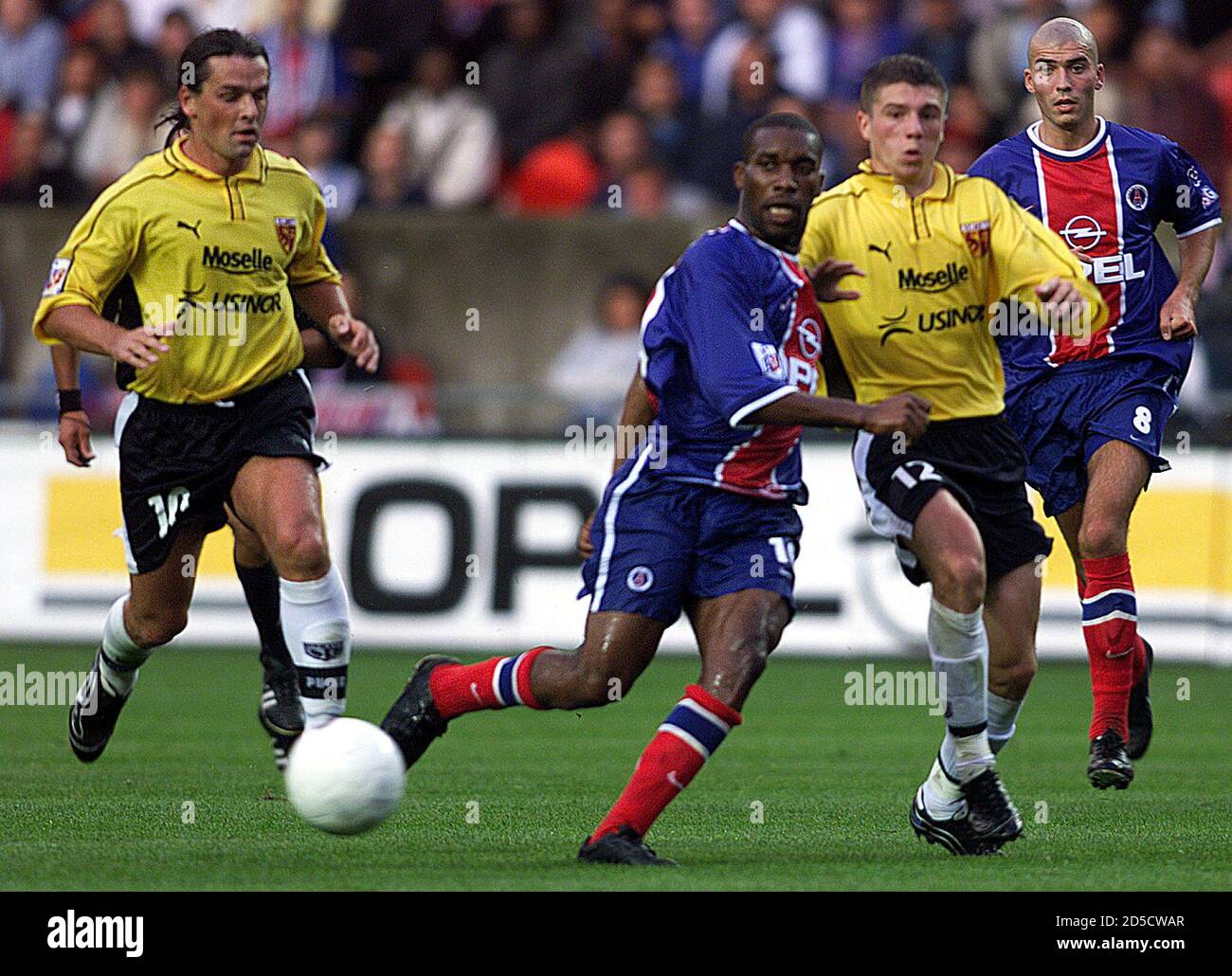 Nigerian Jay Jay Okocha Of Paris Saint Germain 2l Passes The Ball As Team Mate Jerome Leroy R Looks On Under Attention From Frederic Meyrieu L And Gregory Proment Of Metz During Their French