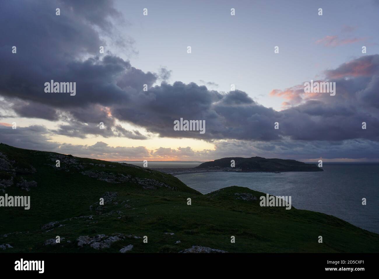 Sunset from the top of the Little Orme overlooking Llandudno and The Great Orme Conwy North Wales UK Stock Photo